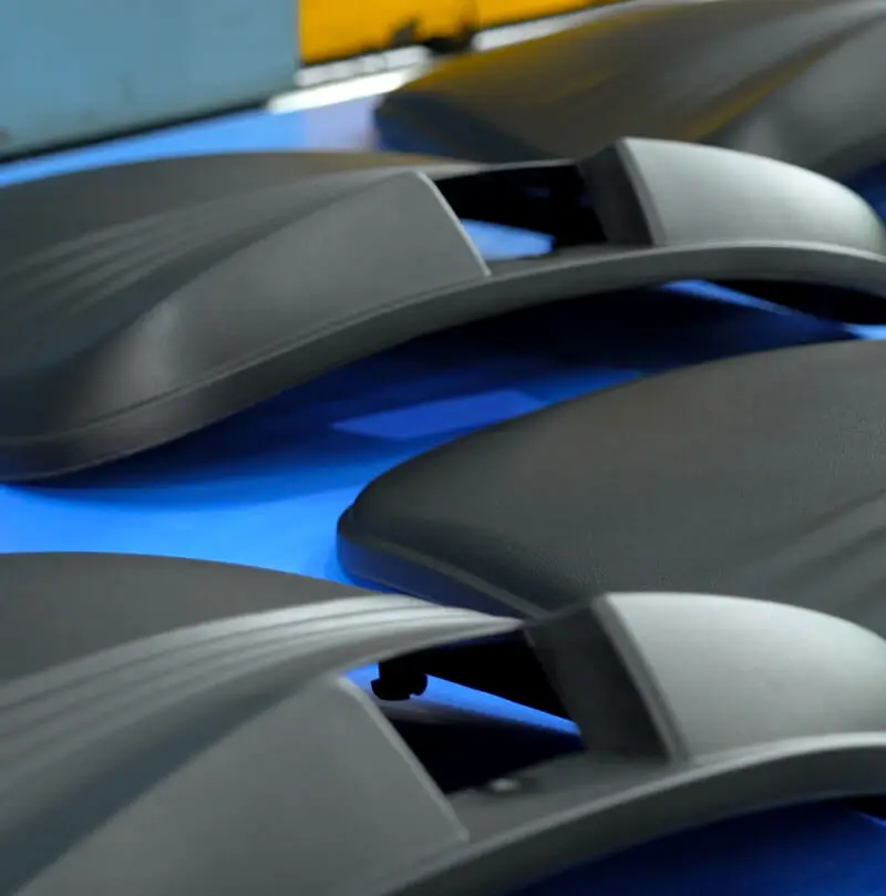 AMP injection-molded black plastic components staged after production