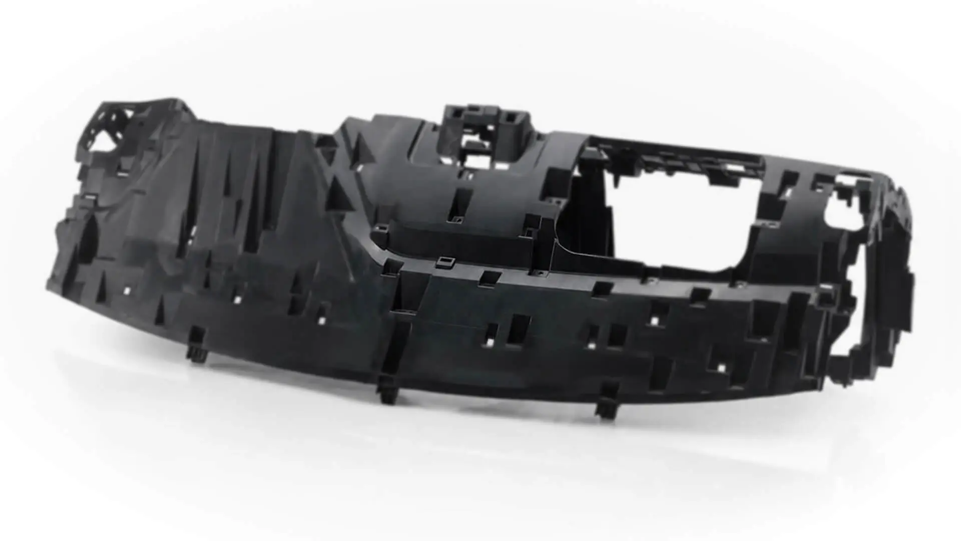 Injection-molded automotive dashboard carrier structural plastic component manufactured by AMP