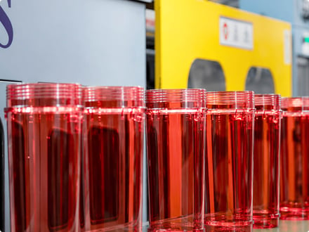 Clear red Eco Elephant polycarbonate bodies staged on the AMP production line after molding