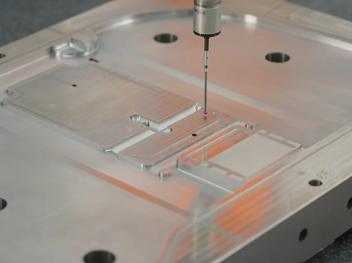 AMP verifying a machined mold plate on our CMM with a Renishaw probe, confirming critical dimensions before export mold shipment