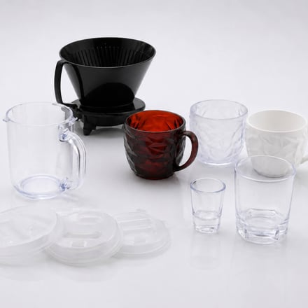AMP injection-molded drinkware range including coffee drippers, cups, and tumblers in Tritan and PP, with clear, colored, and opaque finishes