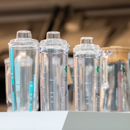 AMP injection-molded clear Tritan water bottles in multiple sizes and cap styles for food and beverage OEM programs