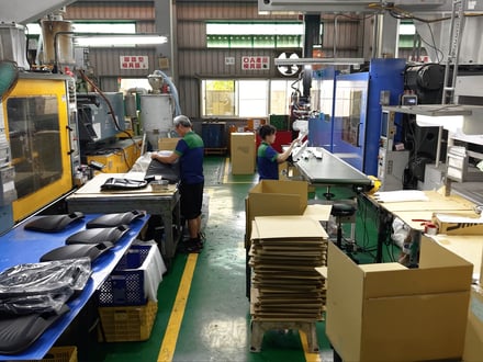 AMP's injection molding production floor with JSW 5200H and multiple mid-to-large tonnage presses equipped with robotic extraction, part of our 52-machine fleet