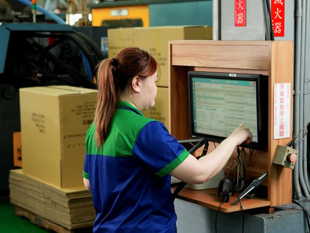 AMP operator tracking injection molding production data on our factory floor system, supporting process control and scheduling across 24-hour operations