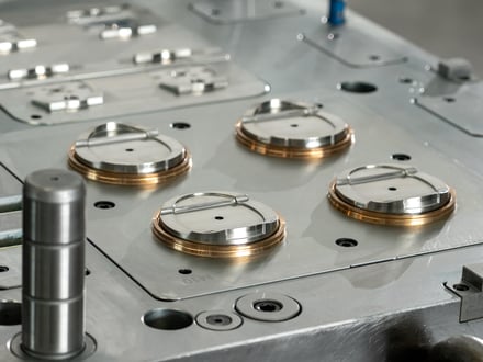AMP-assembled multi-cavity injection mold with precision-fitted cavity inserts, bronze guide rings, and guide pins ready for trial