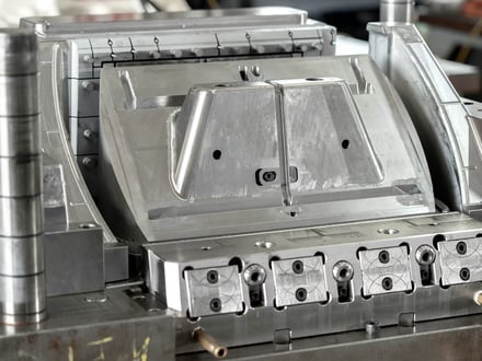 AMP-assembled large-format injection mold with slide actions and locking mechanisms, built for structural automotive components