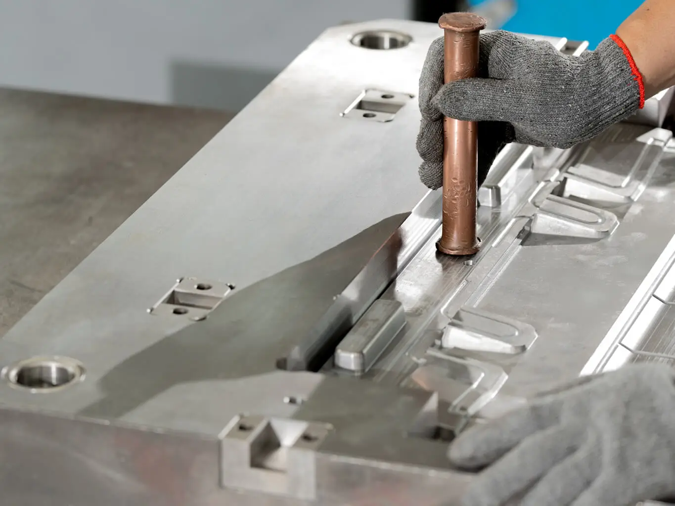 AMP toolmaker using a copper drift to fit and seat inserts into a mold cavity during assembly, where your injection mold becomes production-ready