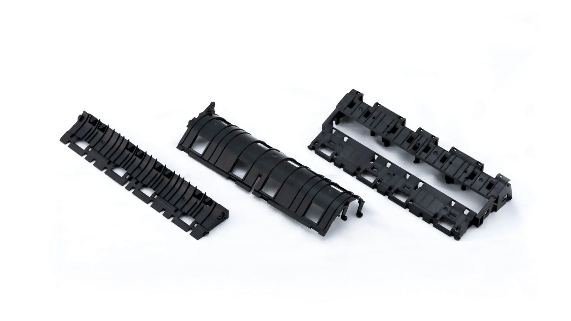 Three black injection-molded connector housing components with snap-fit features for industrial applications, manufactured by AMP