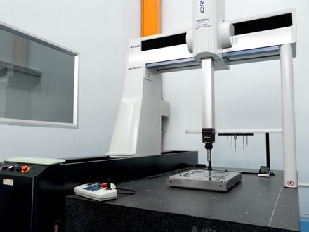 AMP verifies mold components and finished parts against drawing specs on a CMM, housed in a temperature-controlled room to reduce measurement error