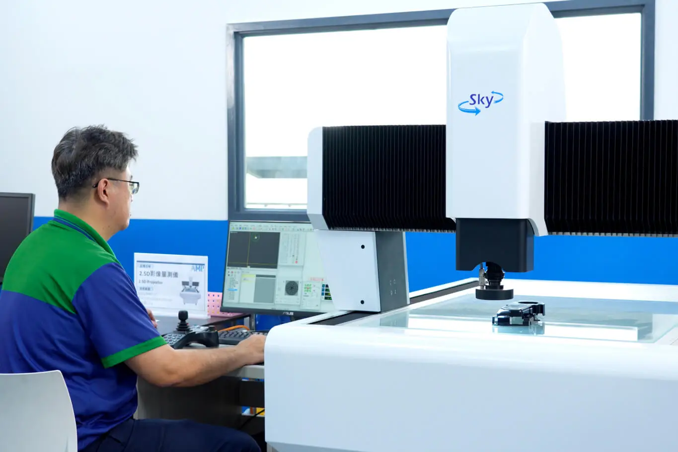 AMP technician operating in-process measurement and CCD visual inspection equipment during a molding run