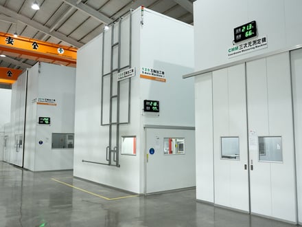 AMP houses its three 5-axis CNC machines and Coordinate Measuring Machine in separate climate-controlled rooms with live temperature and humidity displays for consistent machining accuracy