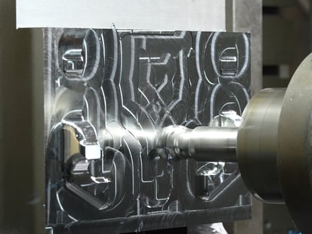 AMP CNC machining detailed cavity features into a steel mold component, with all cutting done in-house