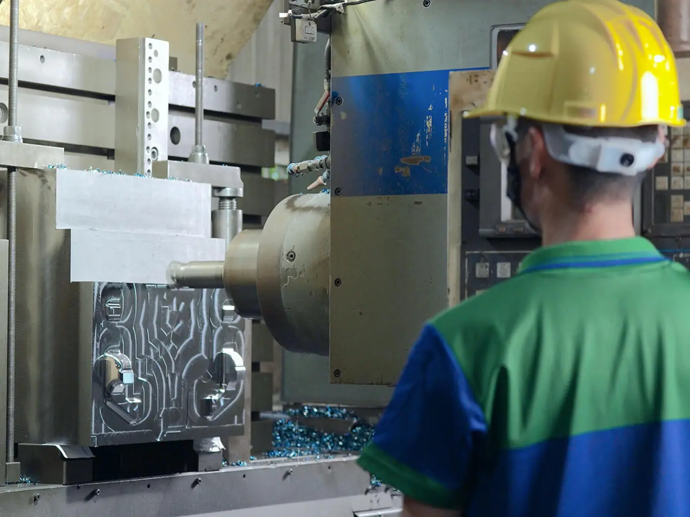 AMP machines mold bases in-house on large-capacity CNC equipment, keeping heavy cutting operations and tooling accountability under one roof