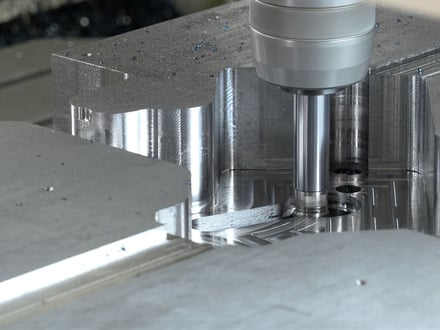 AMP CNC machining precise pockets and profiles into a steel mold component using high-speed end milling